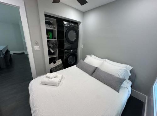 a bedroom with a white bed with a speaker at The Cove at Lake Murray in Chapin