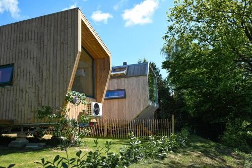 a small wooden house with a fence in a yard at Tiny House Pioneer 1 - Salemer See in Salem