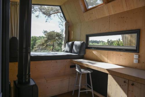 a tiny house with a desk and a window at Tiny House Pioneer 1 - Salemer See in Salem