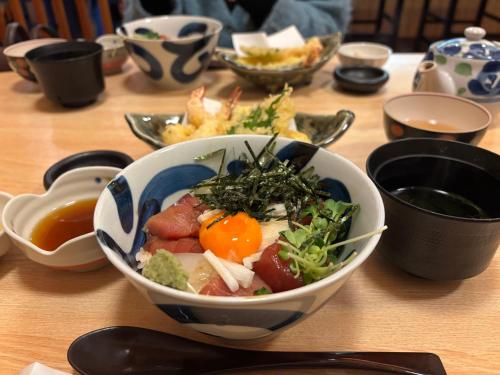 a bowl of food sitting on top of a table at 最大9名可 無料駐車場付 和モダン1棟貸切 4独立寝室 乾燥機付 in Gifu