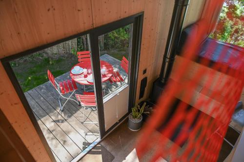 an outside view of a table and chairs on a deck at Tiny House Pioneer 1 - Salemer See in Salem