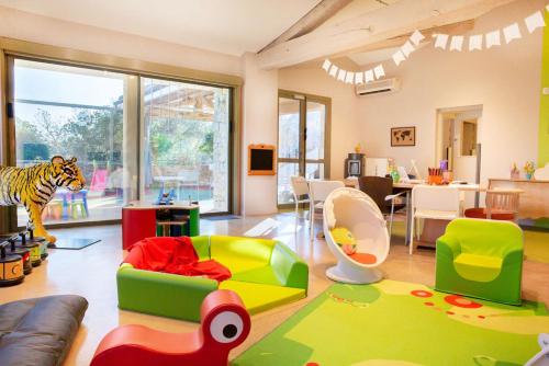 a living room filled with lots of childrens furniture at Terre Blanche Hotel Spa Golf Resort in Tourrettes