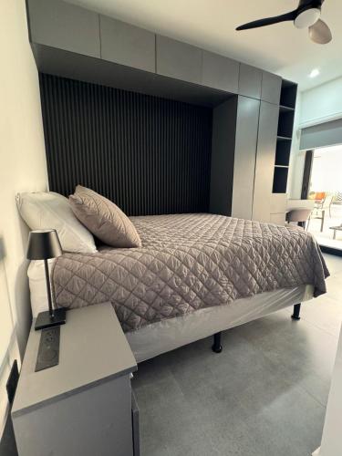 a bedroom with a bed with a black headboard at Ocean Dream Apartment E2-A3 in San Juan del Sur