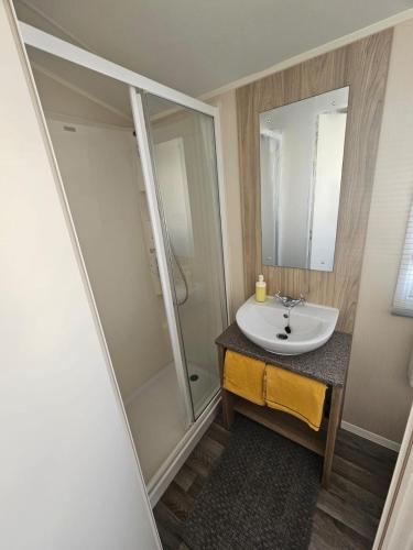 a bathroom with a sink and a shower at AD static Towyn in Kinmel Bay