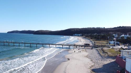 an aerial view of a beach with a pier at Villa Elfeld Appartment 702 in Binz