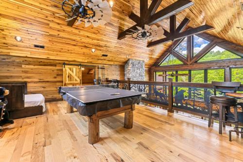 a room with a pool table in a cabin at Enchanting Riverscape in Townsend