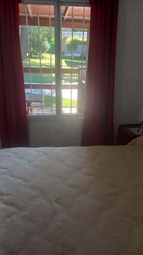 a bedroom with a bed in front of a window at tu lugar para descansar in Valle Hermoso