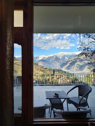 a view of a table and chairs from a window at The Dreamy Chalet in Nagar