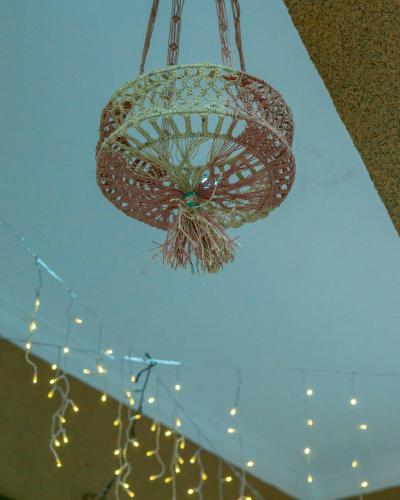 a chandelier hanging from a ceiling with lights at Serengeti in Mbeya