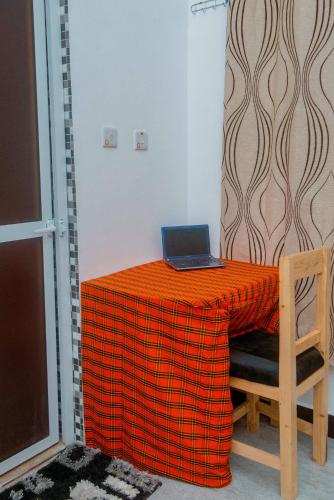a laptop computer sitting on a table in a room at Serengeti in Mbeya
