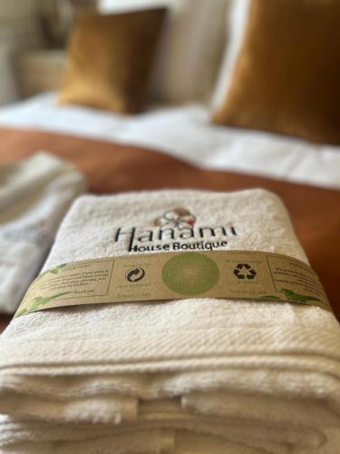 a pile of towels sitting on top of two beds at CR Hanami House Boutique in Navaconcejo