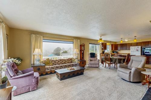 a living room with a couch and a table at Ocean View Terrace in Lincoln City