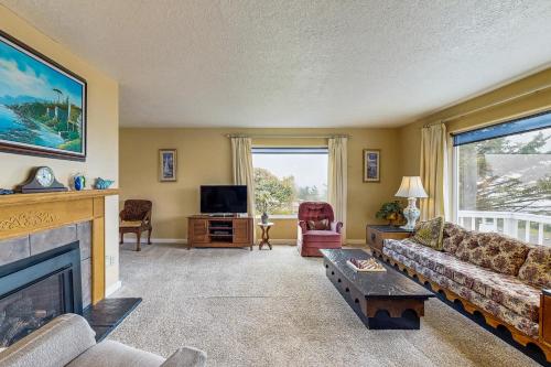 a living room with a couch and a fireplace at Ocean View Terrace in Lincoln City