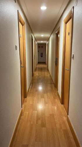 a long hallway with wooden floors in an apartment at Pensión Lizaso in Irún