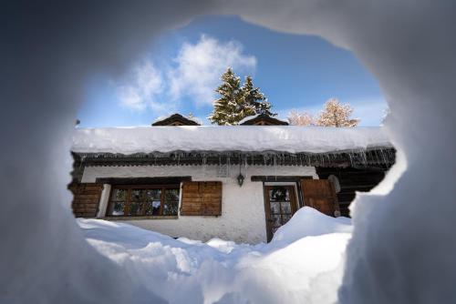a house with snow on the roof of it at Chaletbethere in Pila