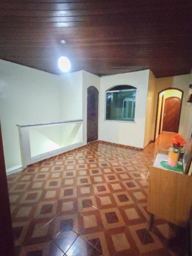 a living room with a wooden ceiling and a room with a table at Casa para COP30 no Centro de Belém in Belém