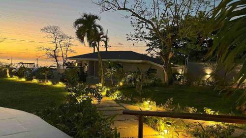 a house with lights in the yard at sunset at The Providence Hotel Boutique in San Andrés