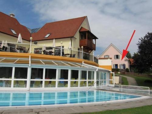 a hotel with a swimming pool in front of a building at Thermen Apartment in Bad Waltersdorf