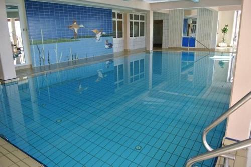 a swimming pool with a painting of people in the water at Thermen Apartment in Bad Waltersdorf