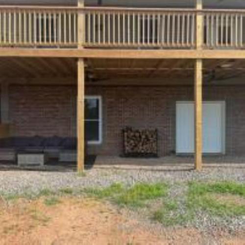 a porch of a brick building with a deck at The Murphy in Sutton