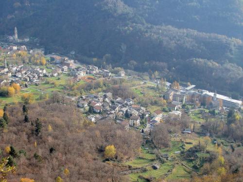 an aerial view of a small town in the mountains at San Carlo in Chiavenna