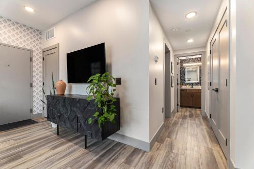 a hallway of a home with a tv on a wall at Brand New Condo in the Heart of Traverse City! in Traverse City