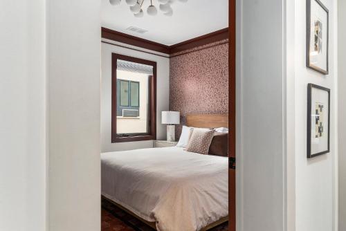 a bedroom with a bed and a mirror at Brand New Condo in the Heart of Traverse City! in Traverse City