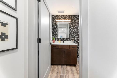 a bathroom with a sink and a mirror at Brand New Condo in the Heart of Traverse City! in Traverse City