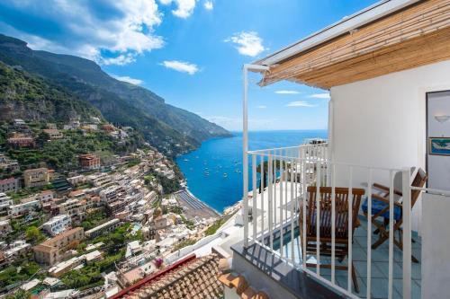 a balcony with a view of a city and the ocean at Casa Berenice Positano in Positano