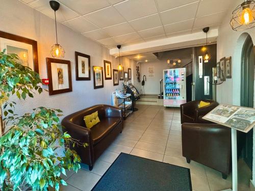 a waiting room with leather couches and a pharmacy at Hôtel de France Contact-Hôtel in Évian-les-Bains