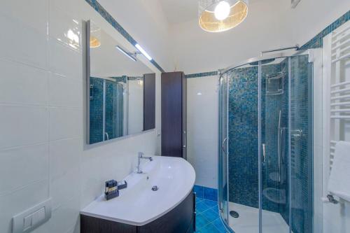 a bathroom with a sink and a glass shower at Casa Berenice Positano in Positano