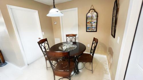 a dining room with a black table and chairs at BlockHaven near Legoland, Disney in Winter Haven