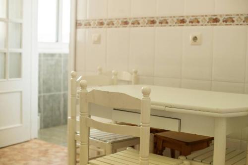 a bathroom with a white table and a mirror at Durmiendo en el Paraiso in Llanes