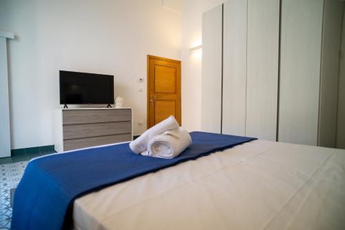 a bedroom with a bed with a tv on a dresser at View of the Tower, accommodation in the historic center and WiFi in Galatina