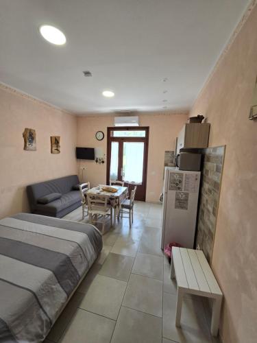 a bedroom with a bed and a couch and a table at Agriturismo le Fontane - Lago di Bolsena in Grotte di Castro