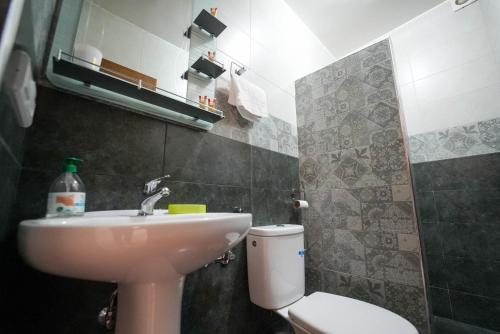 a bathroom with a sink and a toilet at Imi Waves Studio - Steps from Beach & Surf Spot, Imi ouaddar in Imi Ouaddar