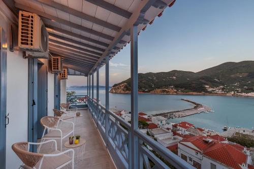 a balcony with chairs and a view of the water at koukou house skopelos in Skopelos Town
