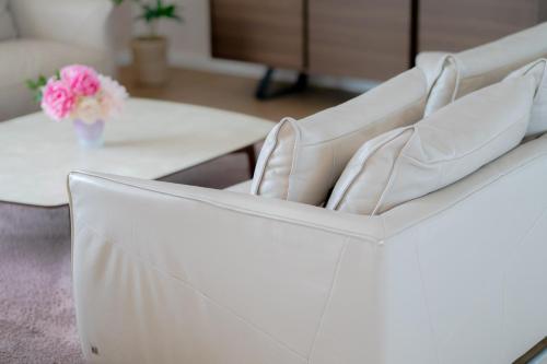 a white couch with a table in a living room at Penthouse Olivia Međugorje - Private Jacuzzi in Međugorje