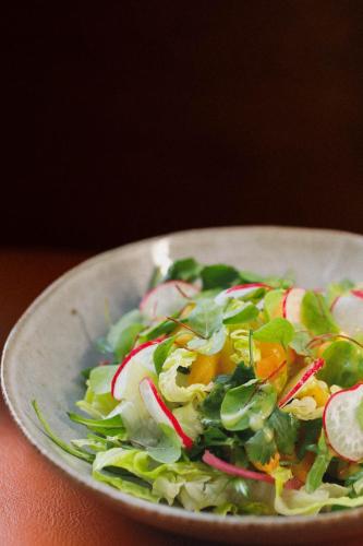a salad in a white bowl on a table at OnJ S. Lazaro Lisboa in Lisbon