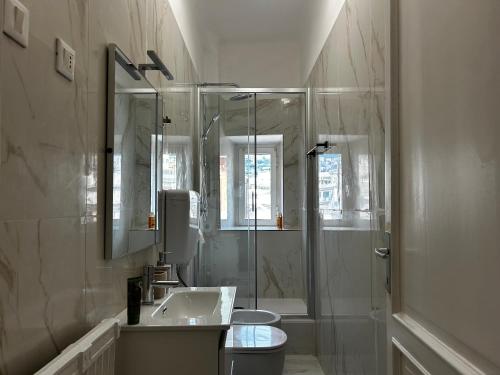 a white bathroom with a sink and a shower at Genova Antica in Genoa
