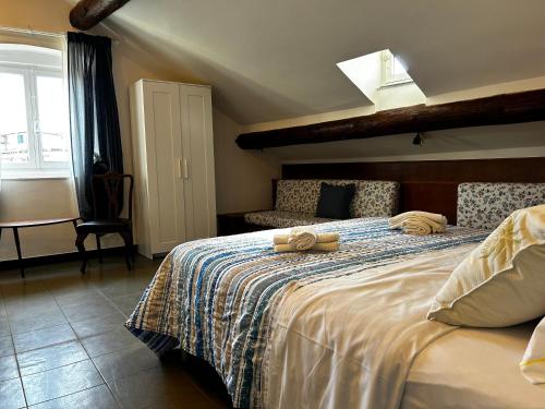 a bedroom with a bed with two towels on it at Genova Antica in Genoa