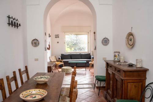 a living room with a table and a couch at Casa Le Anfore in Anacapri