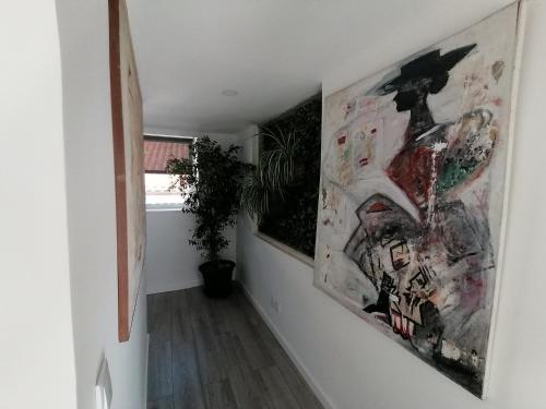a hallway with paintings on the walls of a room at Quinta Castilho in Fortes de Cima