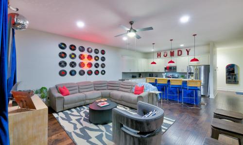 a living room with a couch and a kitchen at The Pardi House by Stay Local Nashville in Nashville