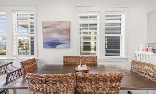 a dining room with a wooden table and chairs at Sol Shine Gulf-View Retreat Steps from the Sand in Mexico Beach