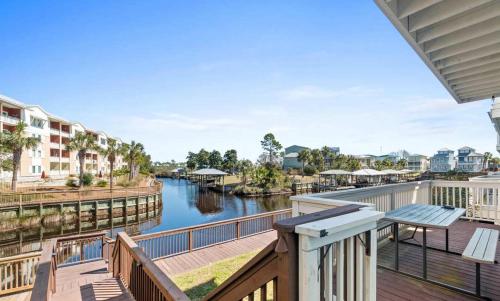 a balcony with a view of a river and buildings at Sol Shine Gulf-View Retreat Steps from the Sand in Mexico Beach