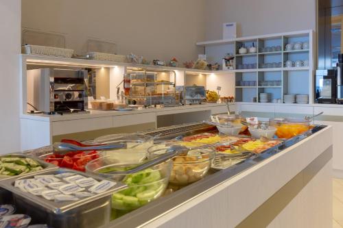 a kitchen with a counter with many containers of food at Hotel Giosue' a mare Sorrento in Meta