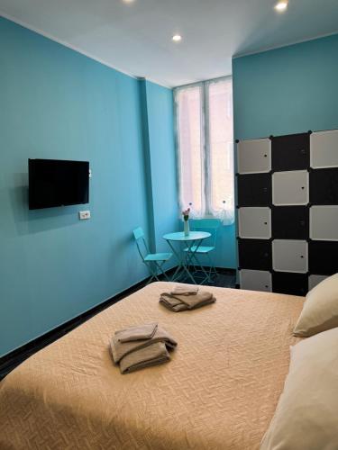 a bedroom with a bed with two towels on it at Il tulipano in Ventimiglia