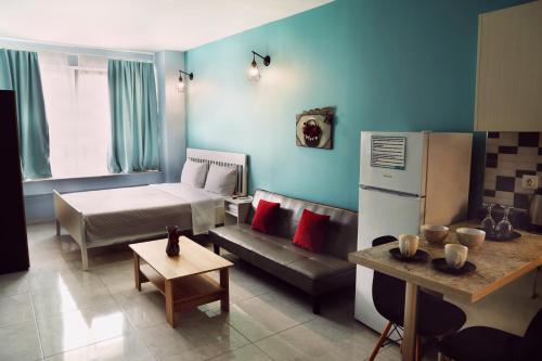 a living room with a couch and a bed at Menta Studios in Thessaloniki