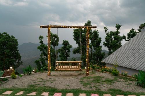 a swing in a yard with lights at Himadvaya- The Himalayan Prism in Almora